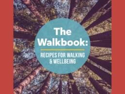 The Walkbook front cover of book with an image looking up into trees on a red background.