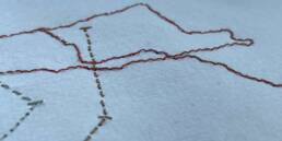 Close-up of stitched lines onto paper