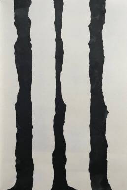 Three black ink tree trunks growing upright with sketchbook paper showing in the gaps in-between.